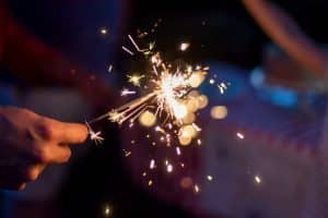 Hand holding sparkles, a traditional easter firework.